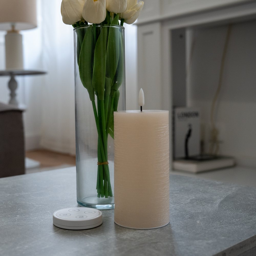Bougie LED et sa télécommande sur une table de salon